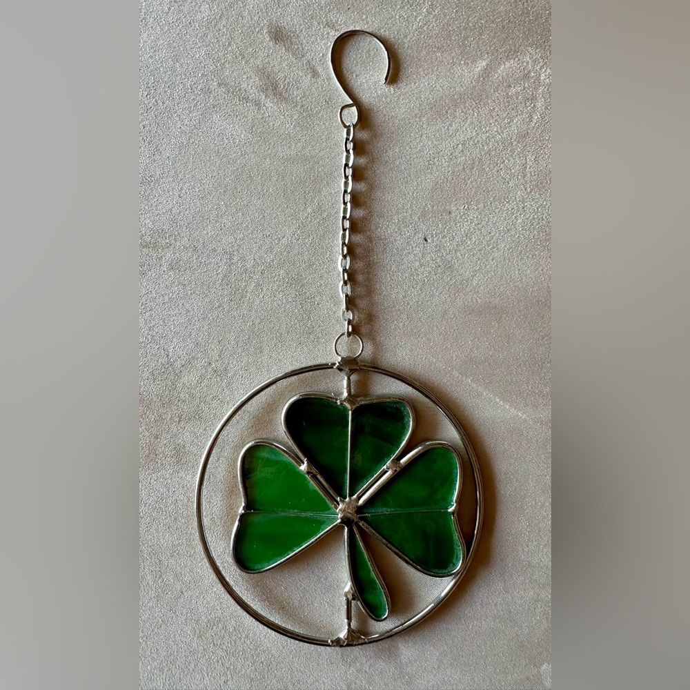 Green Clover Stained Glass Suncatcher hangs from chain and hook. Rotates